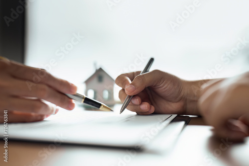 Professional real estate agent guiding and explaining the document process to the customer