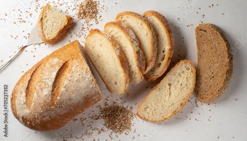 sliced bread on white background crumbs and fresh bread slices close up bakery food concept top view