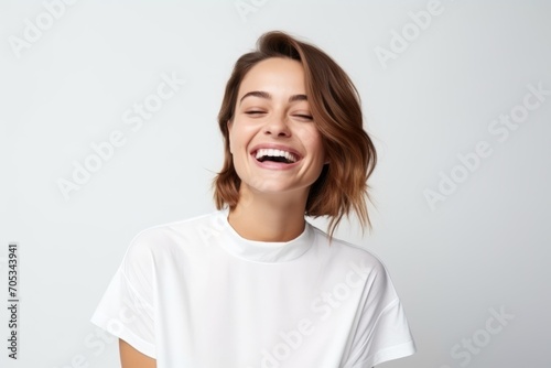 Portrait of a happy young woman laughing, isolated on white background
