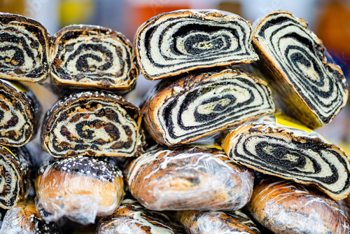 Simtalapis, traditional Lithuanian cake made of yeast dough and poppy seeds, for sale at outdoor farmers market in Vilnius.