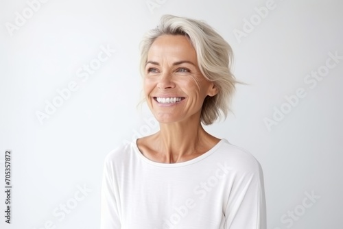 Portrait of a happy mature woman with short blond hair smiling at the camera