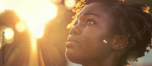 Touched by His Grace. Beautiful young woman looking up with tears in her eyes. Christian concept