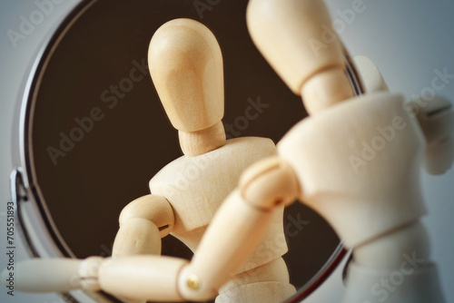 Wooden mannequin looking at himself in the mirror - Concept of interiority, introspection and self-reflection