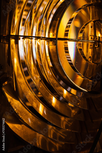 Close up vertical photo of a lighthouse lamp with Fresnel lens