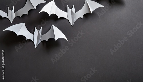 image of gray paper bats on blank black background