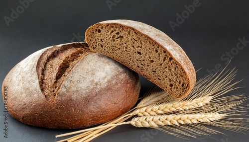 two halves a loaf of rye bread and wheat ears