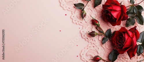  three red roses on a lace doily on a pink background with a place for a text or a picture.