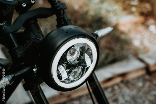 A close-up shot captures the luminous glow of a dirtbike headlight, symbolizing the thrill of off-road adventures under the night sky