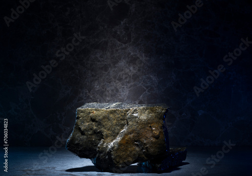 stones and ice for the podium. natural black stones in a thin layer of ice on a dark background for the presentation of a product cosmetics medicine perfumery jewelry