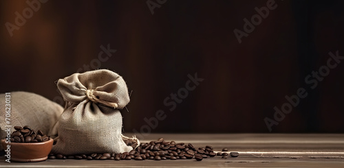 bunch of fresh roasted coffee beans with burlap sack on a wooden table. agriculture and drink concept