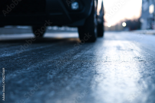 Icy road. Close up photo with the asphalt covered with ice after a freezing rain in the winter morning. Danger for driving.