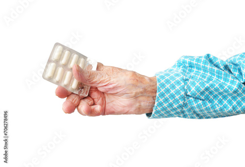 95 year old woman holding pills in hand, isolated on white background.Rheumatoid polyarthritis of the hands.