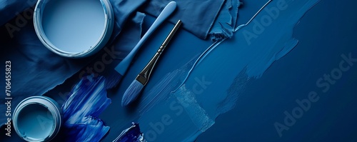 Cobalt dark-blue background, paint cans and brushes on blue background. Painting tools and accessories, house renovation concept. Space for text. AI generated image. 