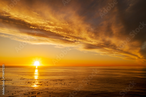 Sunset with golden sky and dramatic clouds