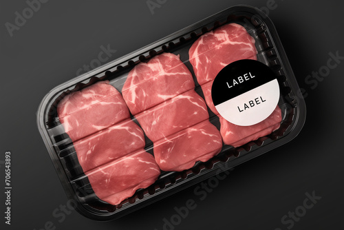 Sealable black plastic tray of fresh raw meat with label texting (have to texting edit)