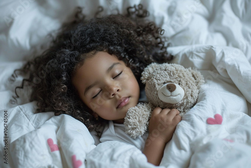 A charming black little girl with curly hair sleeps serenely, gently hugging a soft teddy bear, the concept of sleep and rest, healthy lifestyle and development