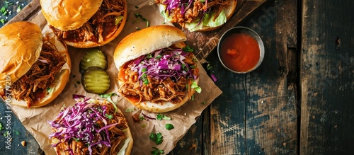 Pulled pork sandwiches with BBQ sauce cabbage and pickles overhead shot. with copy space image. Place for adding text or design