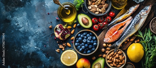 Overhead View of Fresh Omega 3 Rich Foods A variety of healthy foods like fish nuts seeds fruit vegetables and oil rich in omega 3 nutrients. with copy space image. Place for adding text or design