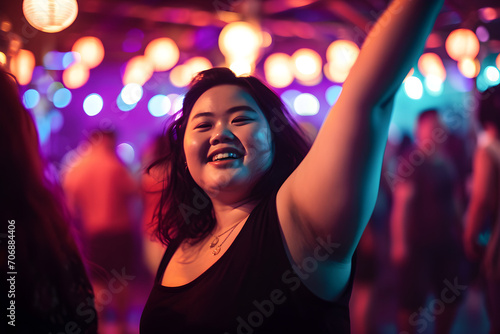 portrait of confident overweight happy dancing Asian woman in crowded nightclub embodying body positivity, selective focus shot with neon lights