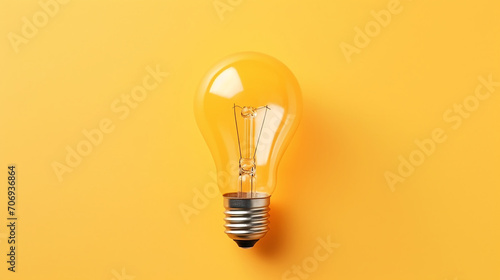 Light bulb on yellow background, top view. Creative idea concept
