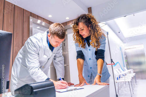 General practitioner doctor filling a form in the hospital