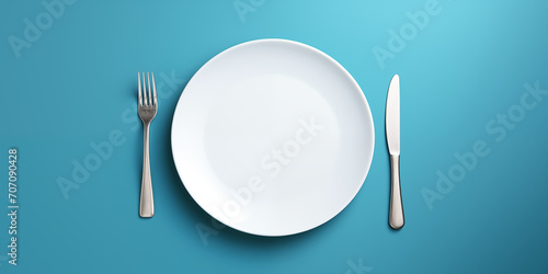 empty white plate with cutlery. isolation on a blue background