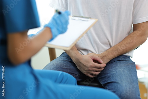 Doctor is diagnosing male erectile dysfunction and giving treatment recommendations, male health problems.