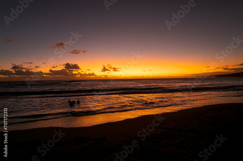 Sunset on the beach of L'Étang-Salé, one of the rare beaches of the island made of volcanic sand, the result of a mixture of basalt and coral, Reunion Island