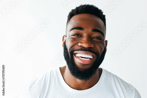 Portrait of a handsome black man smiling a white-hot smile on white background