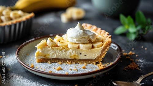 Banana cream pie slice on a plate with whipped cream