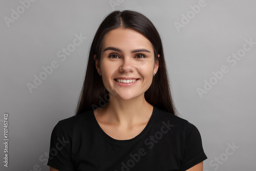 Personality concept. Happy woman on grey background
