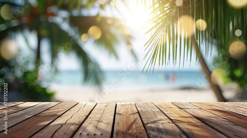Empty wooden table and palm leaves with party on beach blurred background in summer time