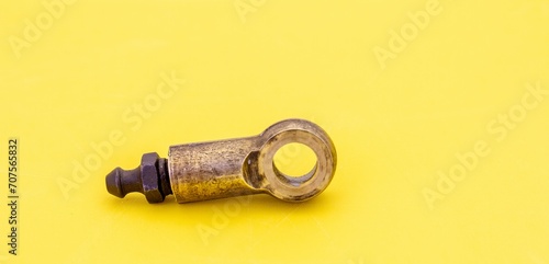 Brass banjo fitting for the rear brake cylinder on a Morris Minor 1000 isolated on a clear background with copy space