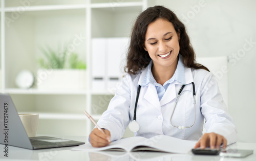 Smiling woman doctor have professional online training on laptop