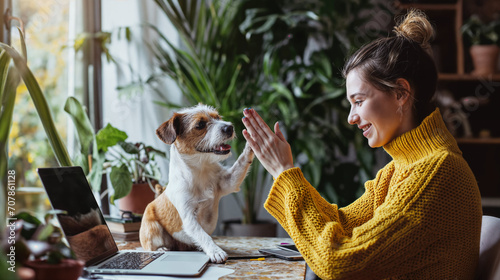 Woman in Yellow Giving High Five to Her Dog at Home Office