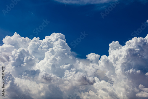 Closeup of Billowy cumulus clouds. Wispy clouds, deep blue sky in background. 