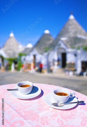 closeup of two cups of Espresso on a table, with empty street out of focus in background in Alberobello in preseason, Alberobello, Apulia, Italy, Europe