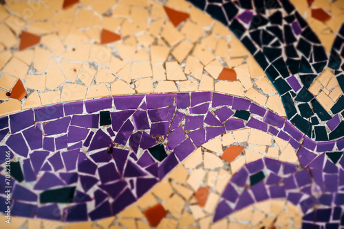 Multicolored violet, orange, yellow ceramic mosaic details. Colorful artwork abstract background. Architecture decoration. Mosaics wall surface.