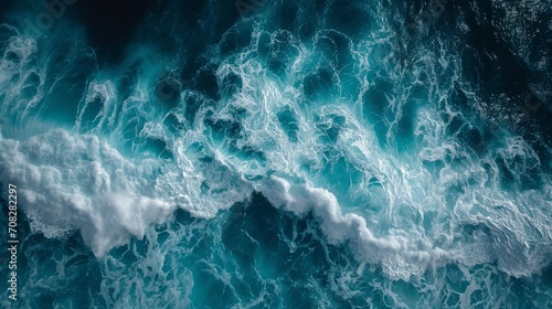 beautiful photo of blue water flowing in waves with white foam in a ocean. taken from up top above perspective. wallpaper background 16:9