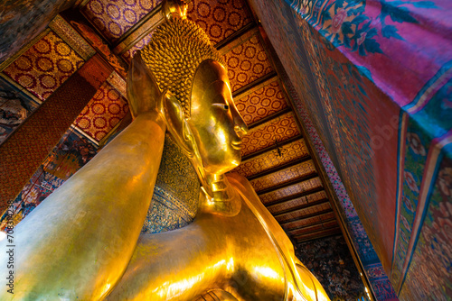 Golden big reclining buddhist statue in temple