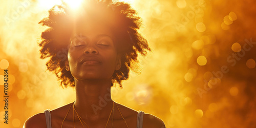 African American woman with healing energy and light around her feeling good breathing calm peace. Happy black female in calmness happiness taking deep breath for zen, health or spiritual wellness