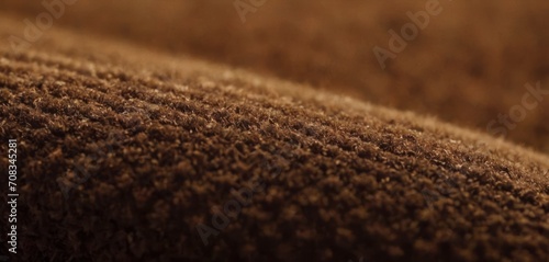  The image features a brown blanket on a couch, and it appears to be a close-up shot. The fabric is made from a mixture of.