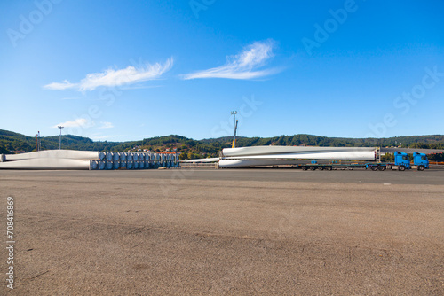 Wind turbine blades are loaded onto a cargo truck in the seaport of Ferrol in Spain.