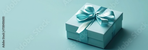 Minimalistic teal gift box with a sleek ribbon, perfect contrast on a soft green background