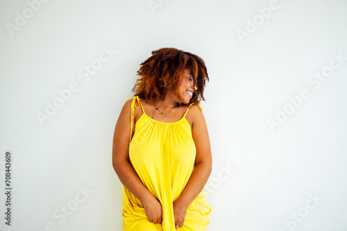 Beautiful curvy oversize young afto american woman in a yellow dress