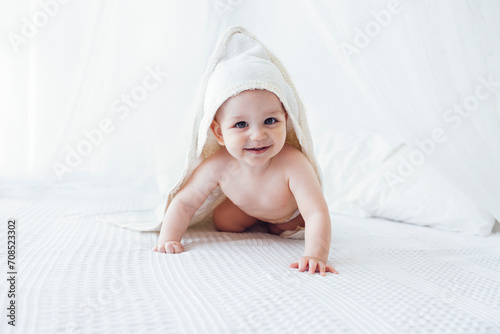 Little cute child wearing hooded towel after bath or shower.