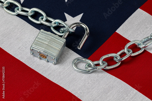 United States flag with unlocked chain. Border security, immigration reform and illegal migrant crisis concept.