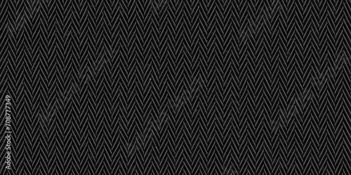 Seamless dark black and grey herringbone tweed textile texture background. Closeup of realistic tileable mottled distressed woolen striped zigzag fabric pattern. High resolution 3D rendering backdrop.