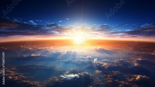 Breathtaking sunset view above the earth's atmosphere, with sun rays scattering through the clouds, invoking a sense of wonder
