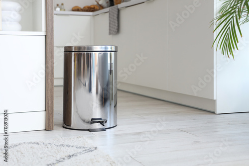 Modern trash bin with foot pedal in kitchen, closeup